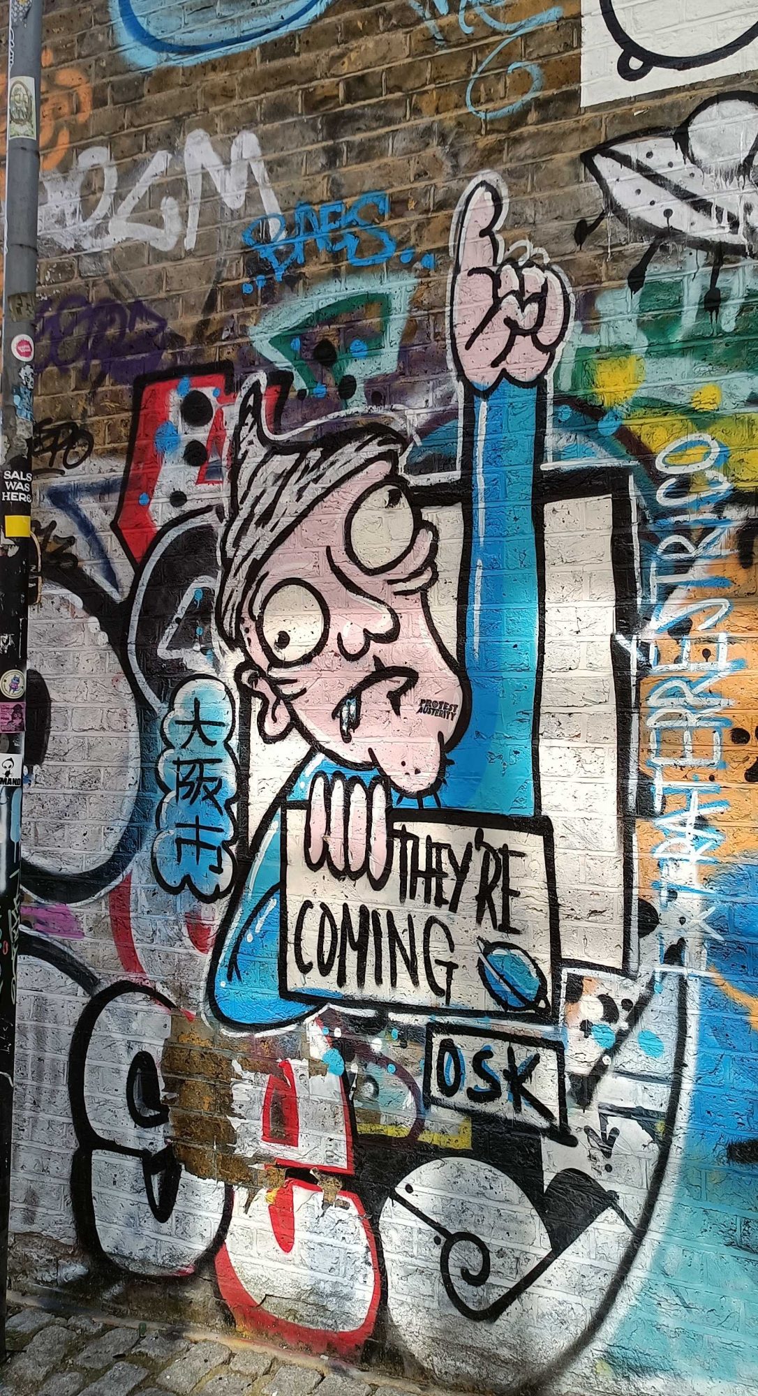 The Man with the "They're Coming" Sign — Street art in London