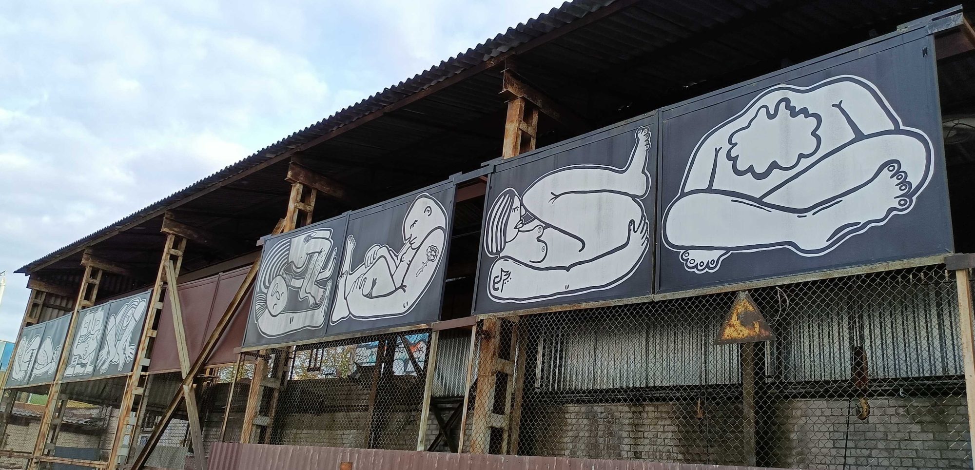 White Figures on Black Panels — Street art by Eglė Narbutaitė in Vilnius