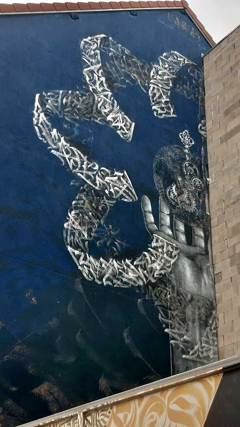 Silver Calligraphy and Outstretched Hand — Street art in Grenoble