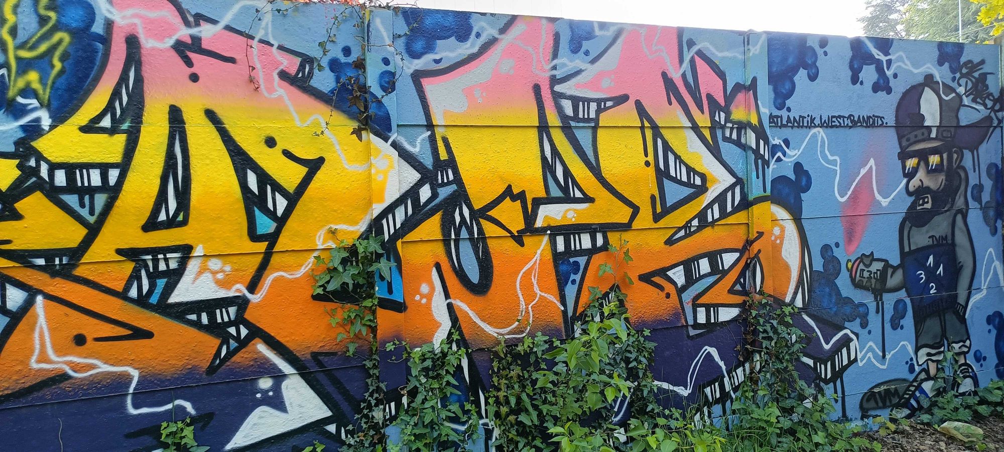 Blazing Lettering and the Character in a Hat — Street art in Nantes