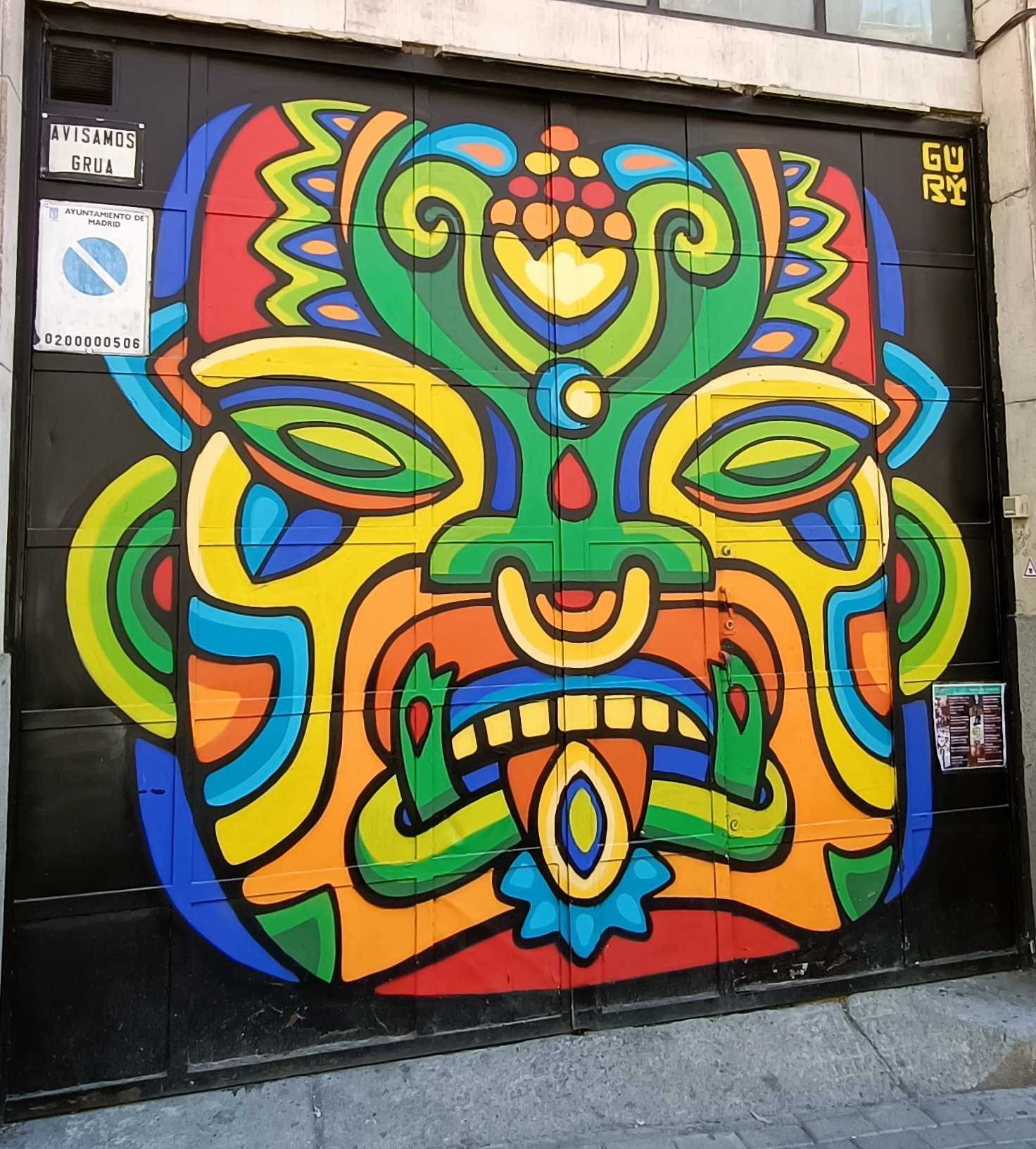 Vibrant Tribal Mask by Guri — Street art by Guri in Madrid