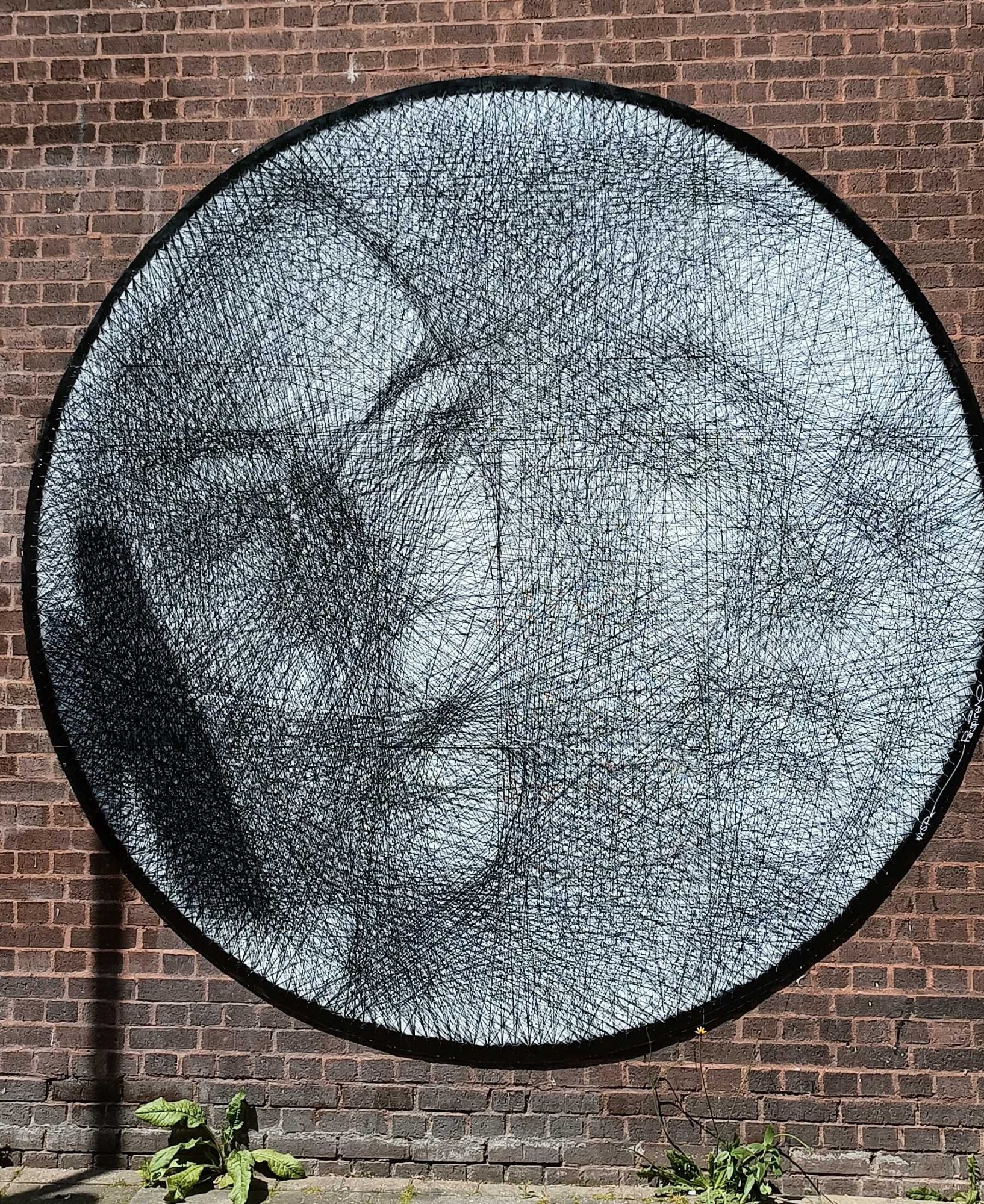 Face in black thread — Street art in London