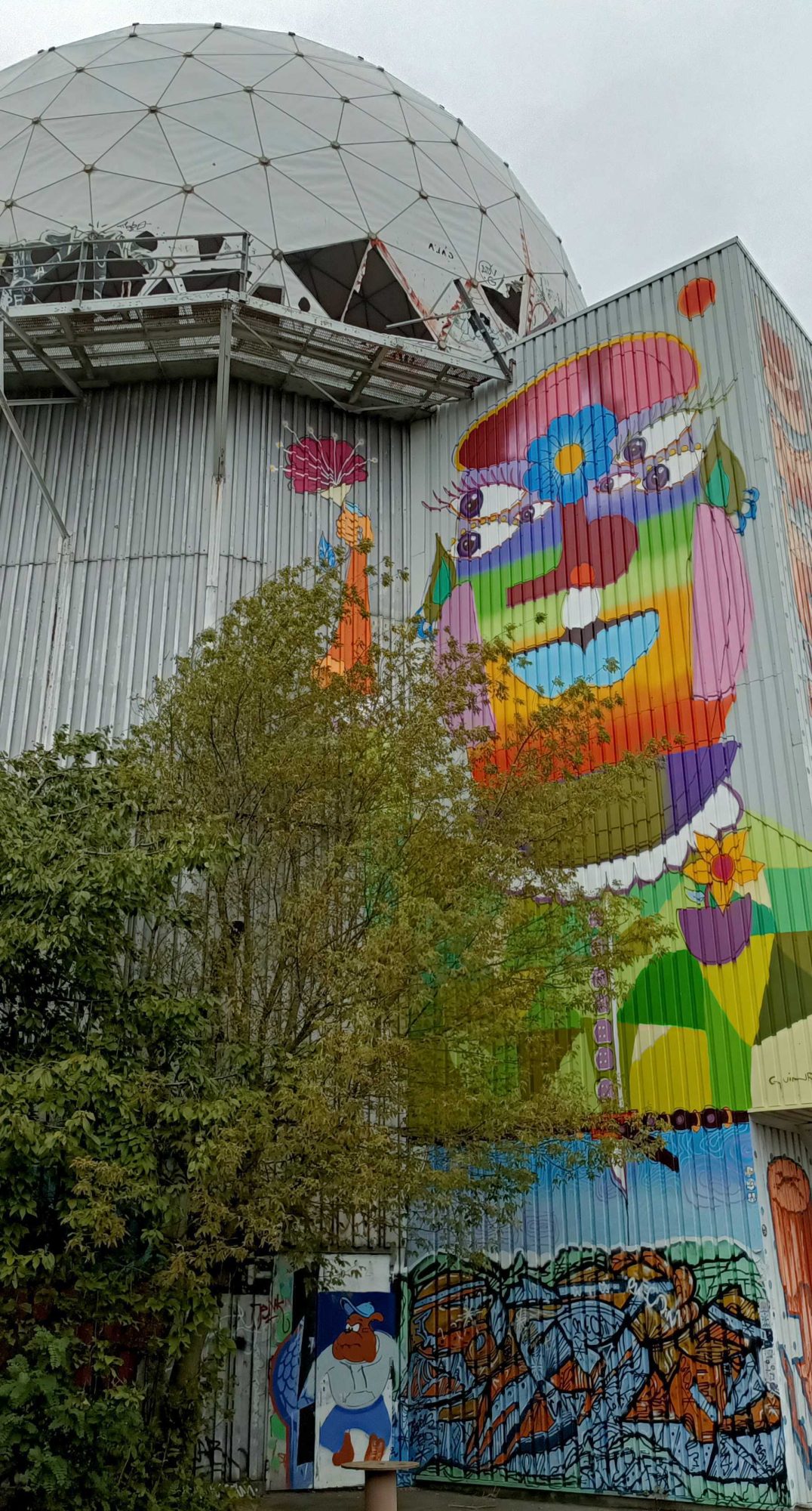 Giant Face Below the Radome — Street art by GUINR in Berlin