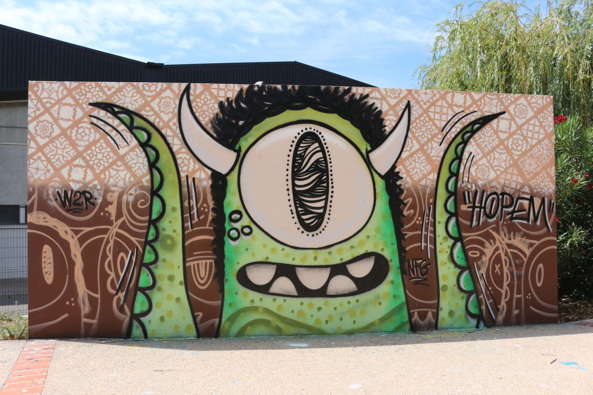 The Green Cyclops of the Skatepark — Street art by Hopem Story in Perpignan