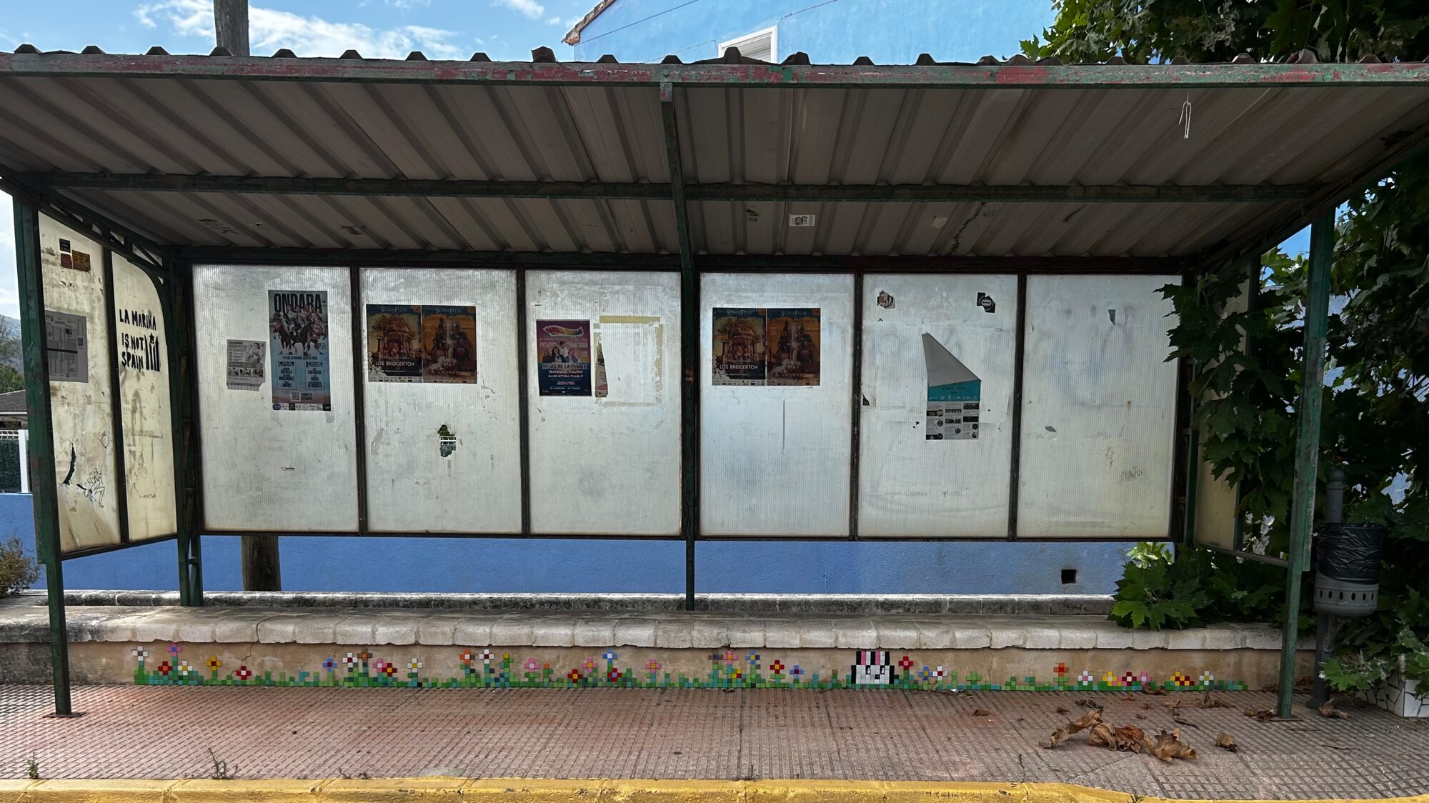 The Bunny and the Bus-Shelter Flowers — Street art by Astro Boy in Beniarbeig