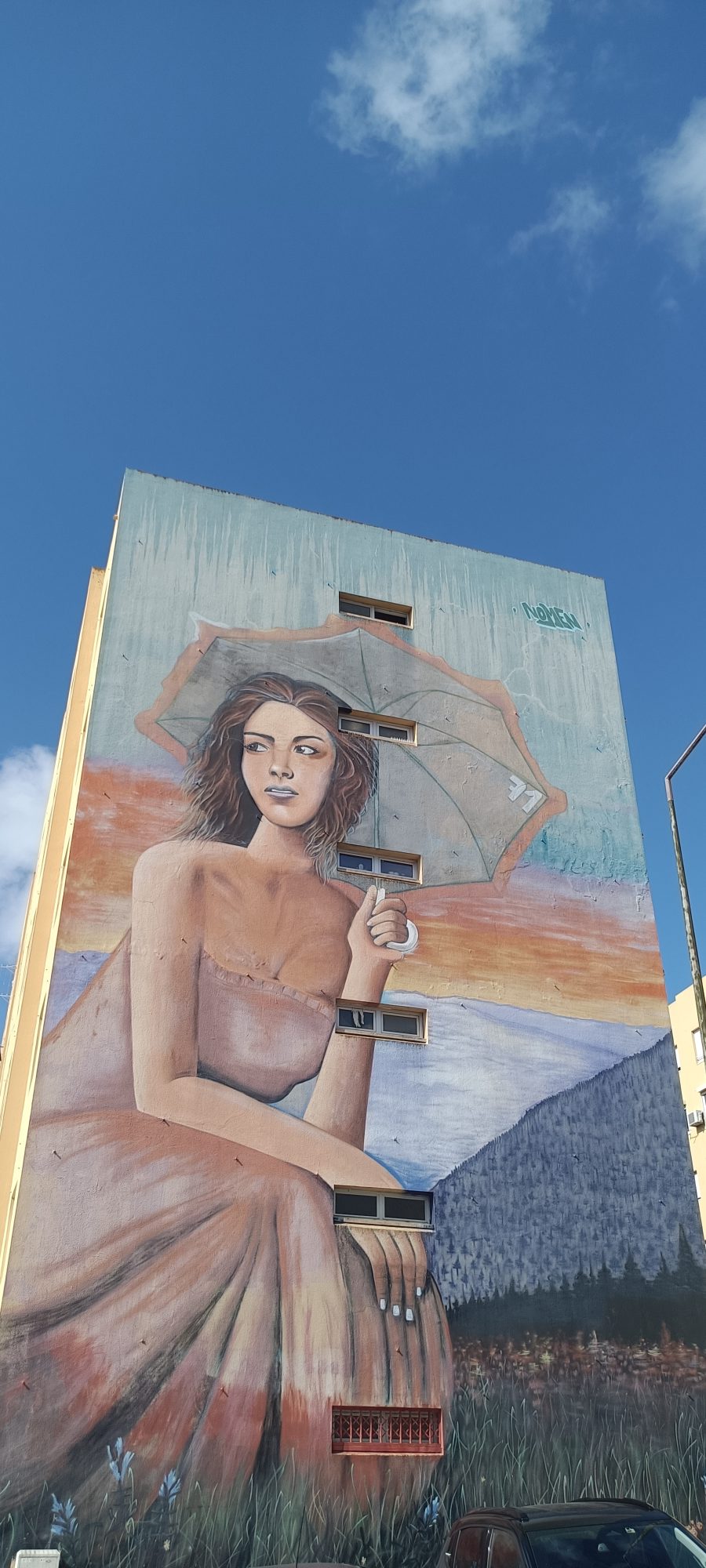 Woman with Parasol Against Landscape — Street art by Nomen in Lisboa