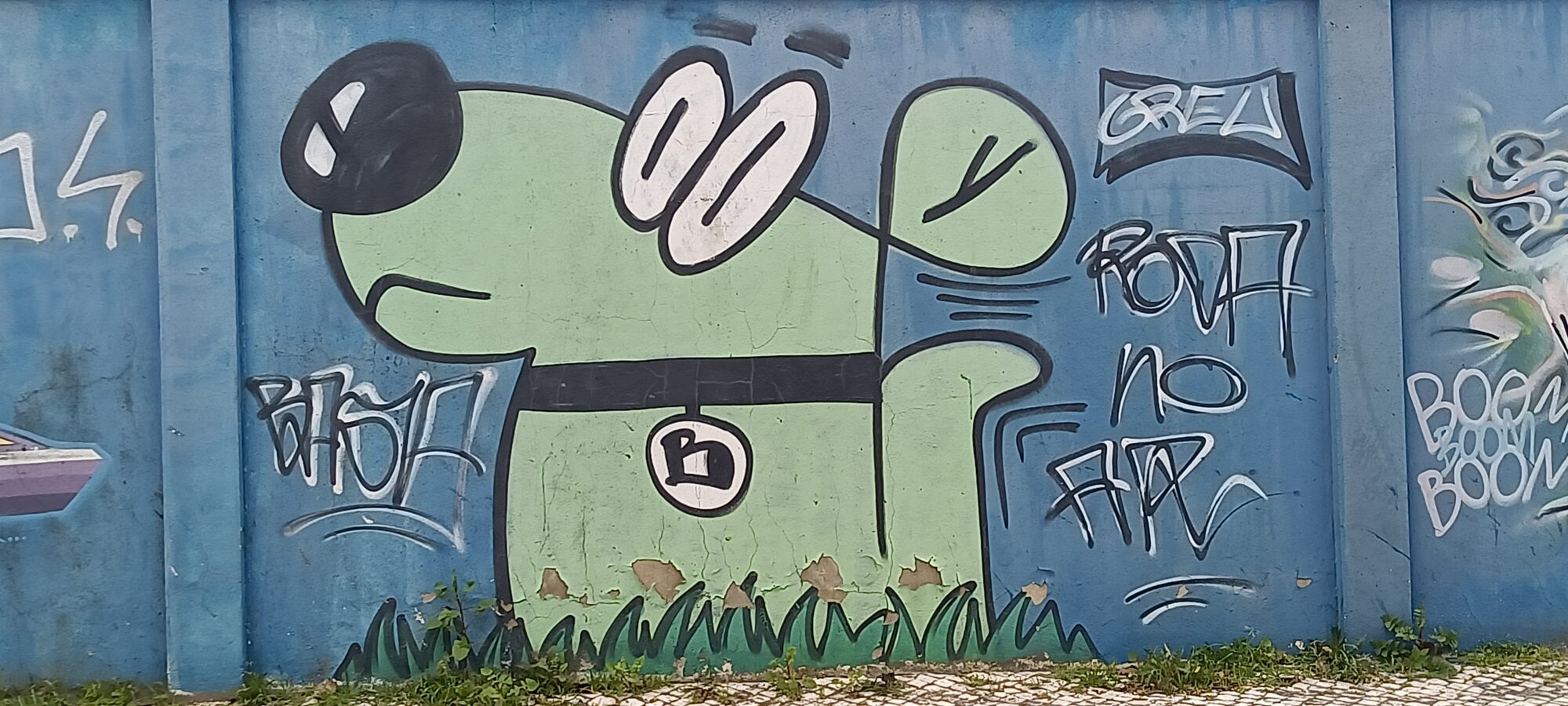Green dog in painted grass — Street art in Lisboa