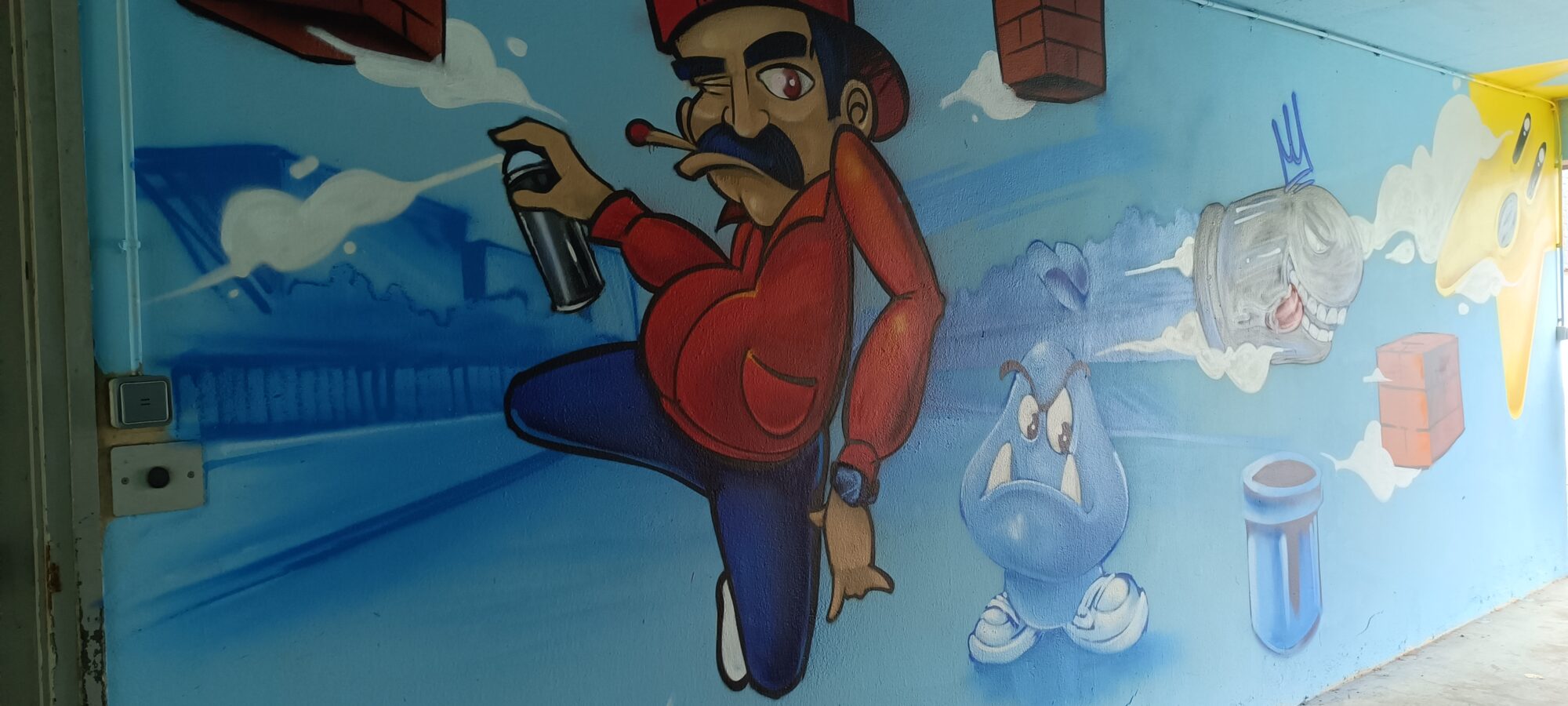 Moustachioed plumber with a spray can — Street art in Paimpol