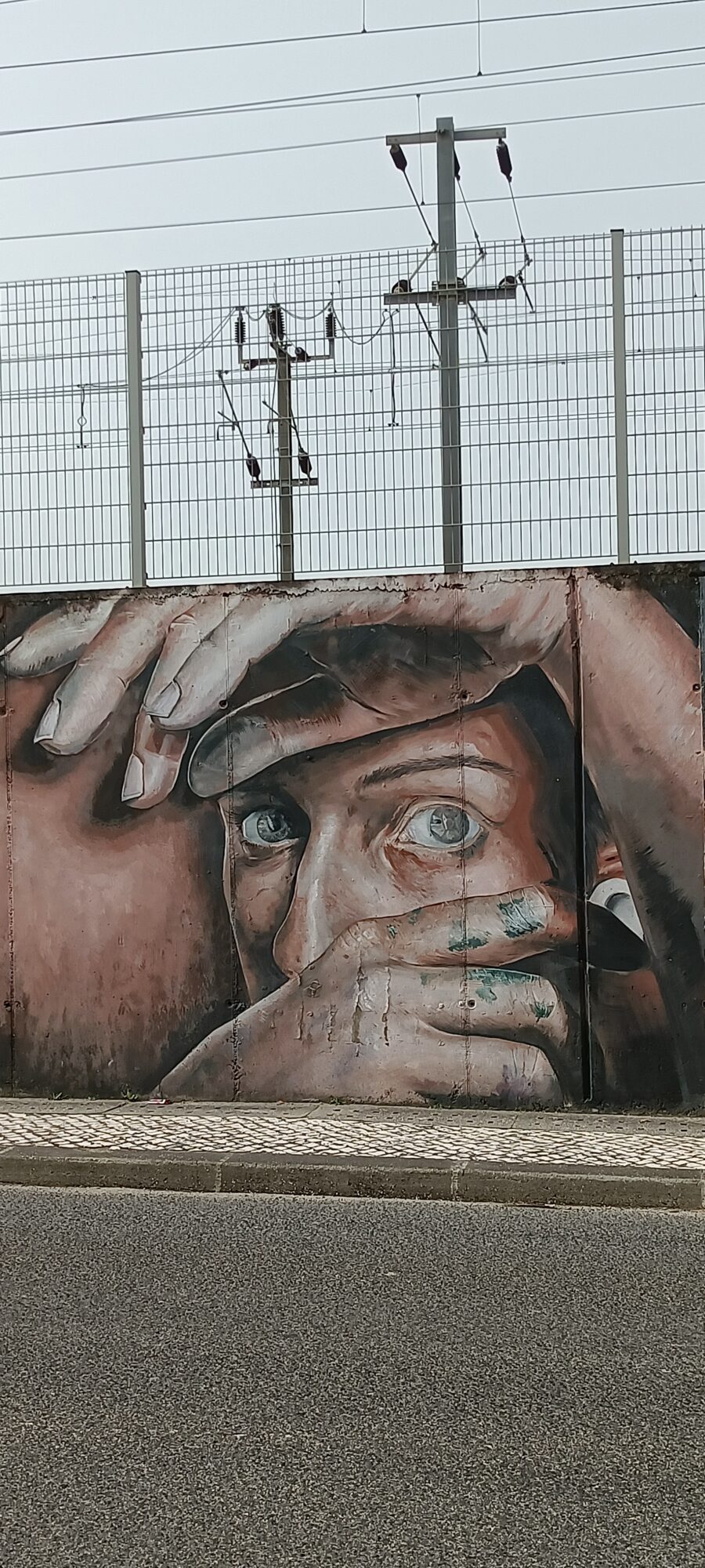 Hands Over the Face, Only the Eyes — Street art by Daniela Guerreiro in Lisboa