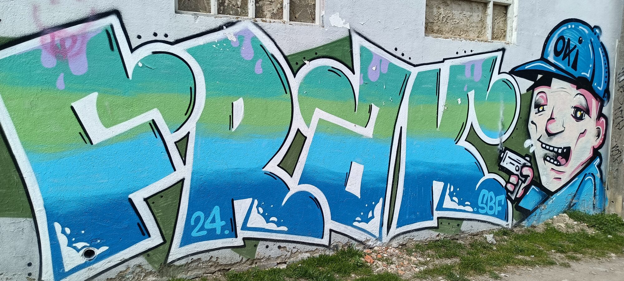 Blue and Green Lettering with Oki Cap Character — Street art in Almada