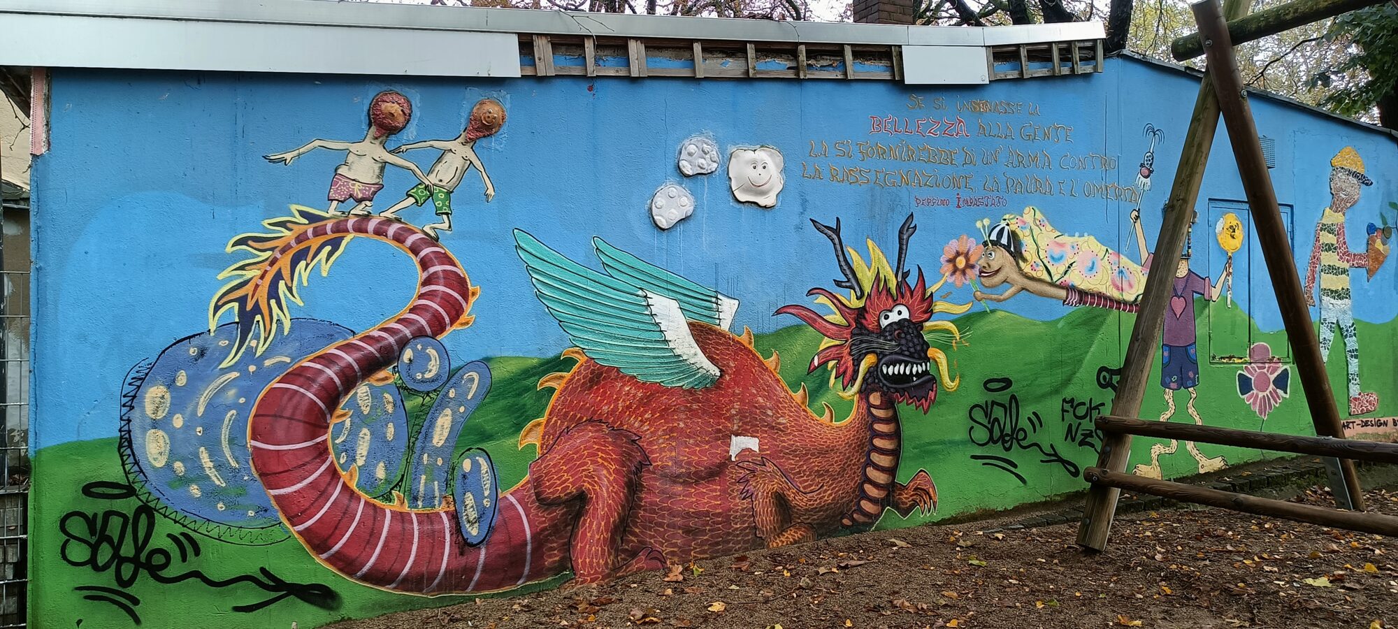 Winged dragon in the schoolyard — Street art in Köln