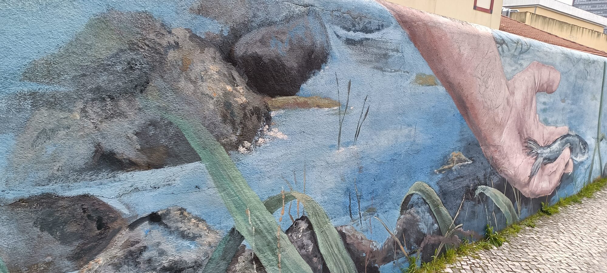 Giant hand and fish in the river — Street art in Lisboa