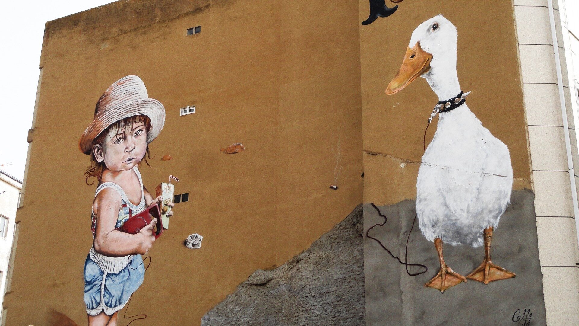 The Girl with the Duck — Street art by El Rojo in La Bañeza