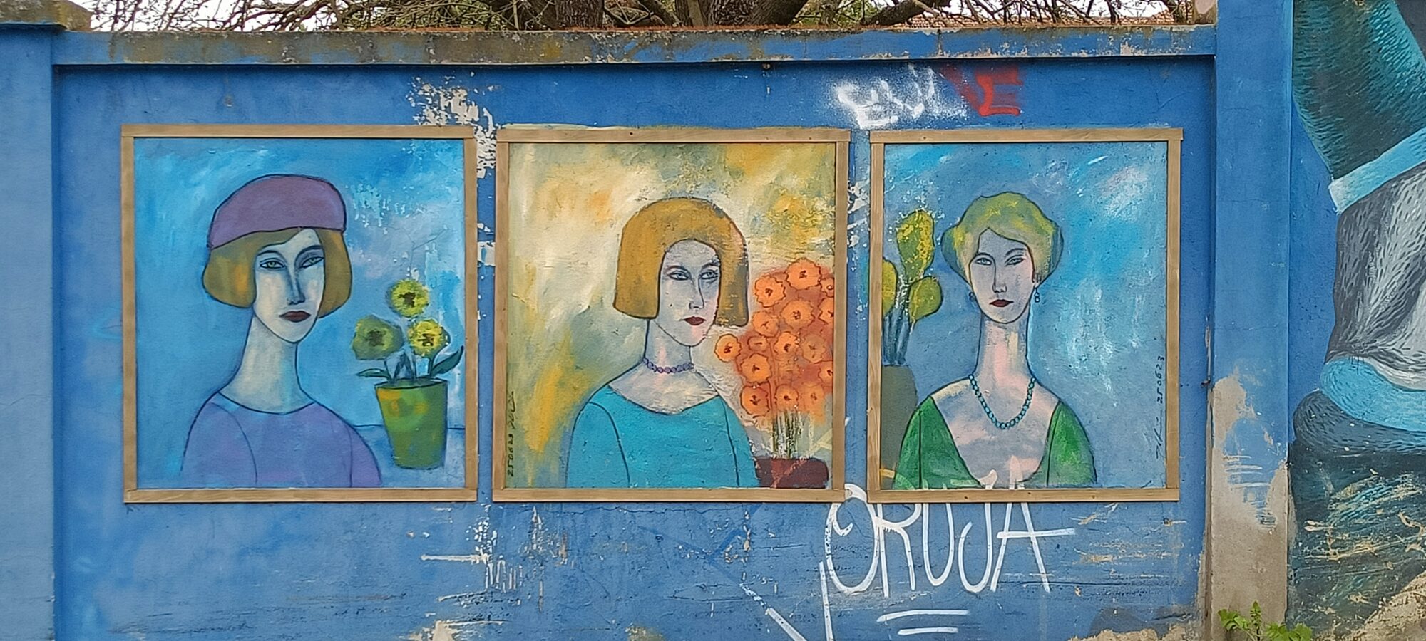Three framed flower-crowned women — Street art in Lisboa