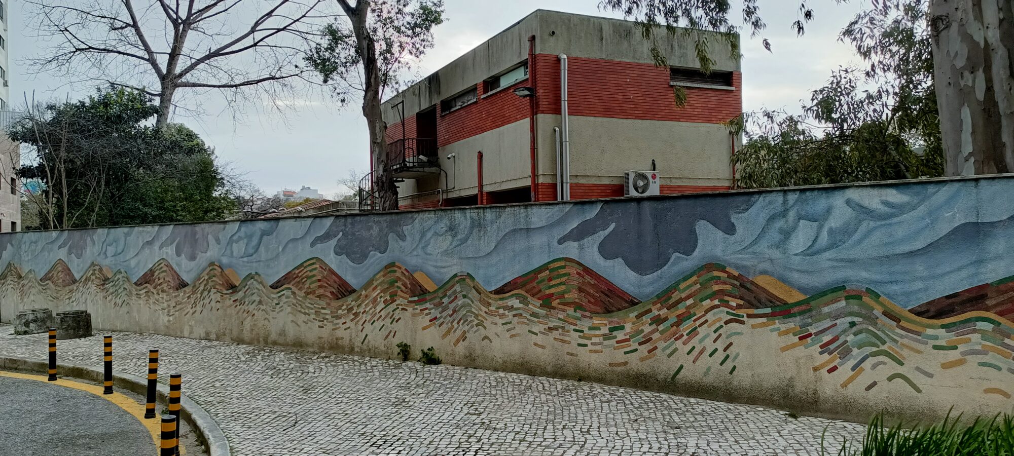 Mountains painted in bands of colour — Street art by Mariana Rio in Lisboa