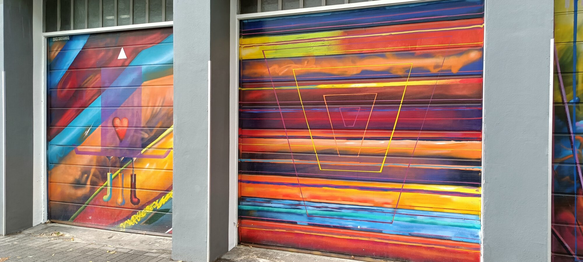 Garage shutters in coloured bands — Street art in Köln