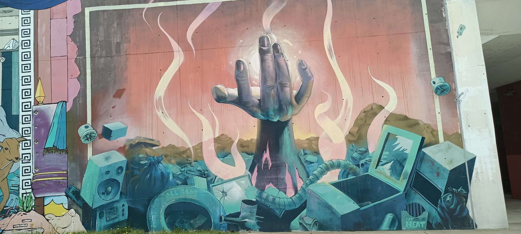 Hand Rising from Electronic Waste — Street art by Fat Heat in Lisboa