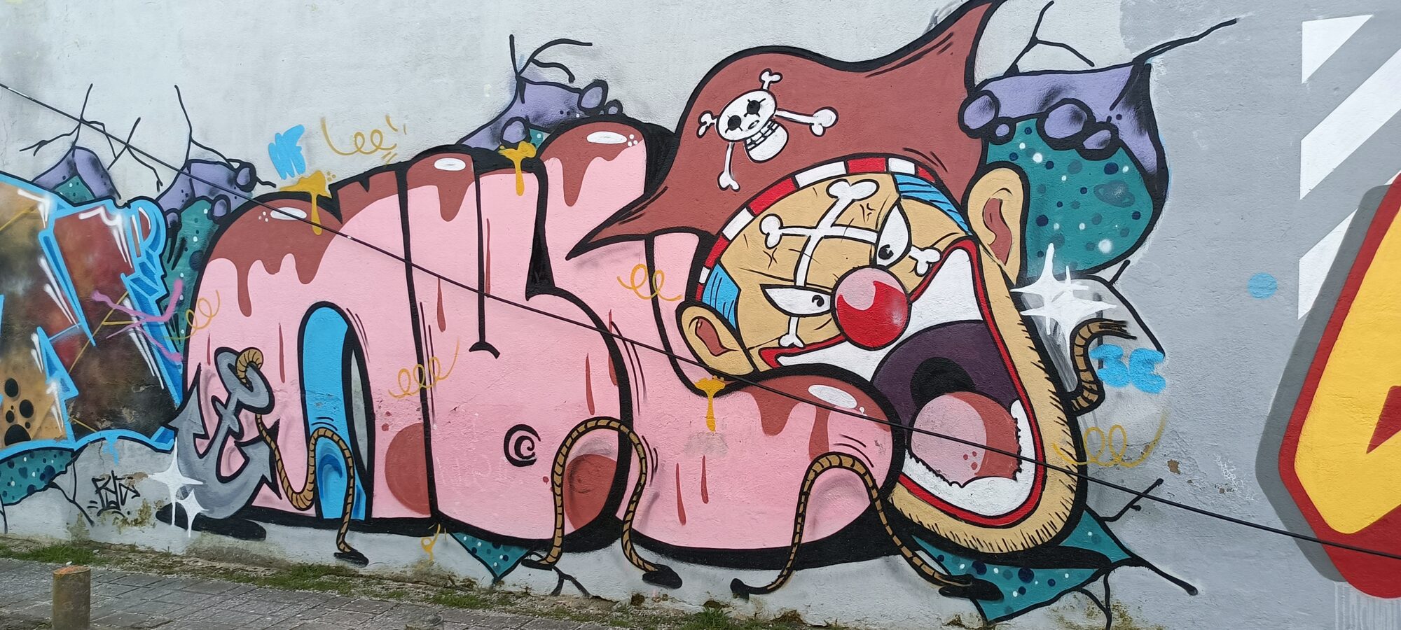 Pink Lettering and Pirate Clown — Street art in Almada