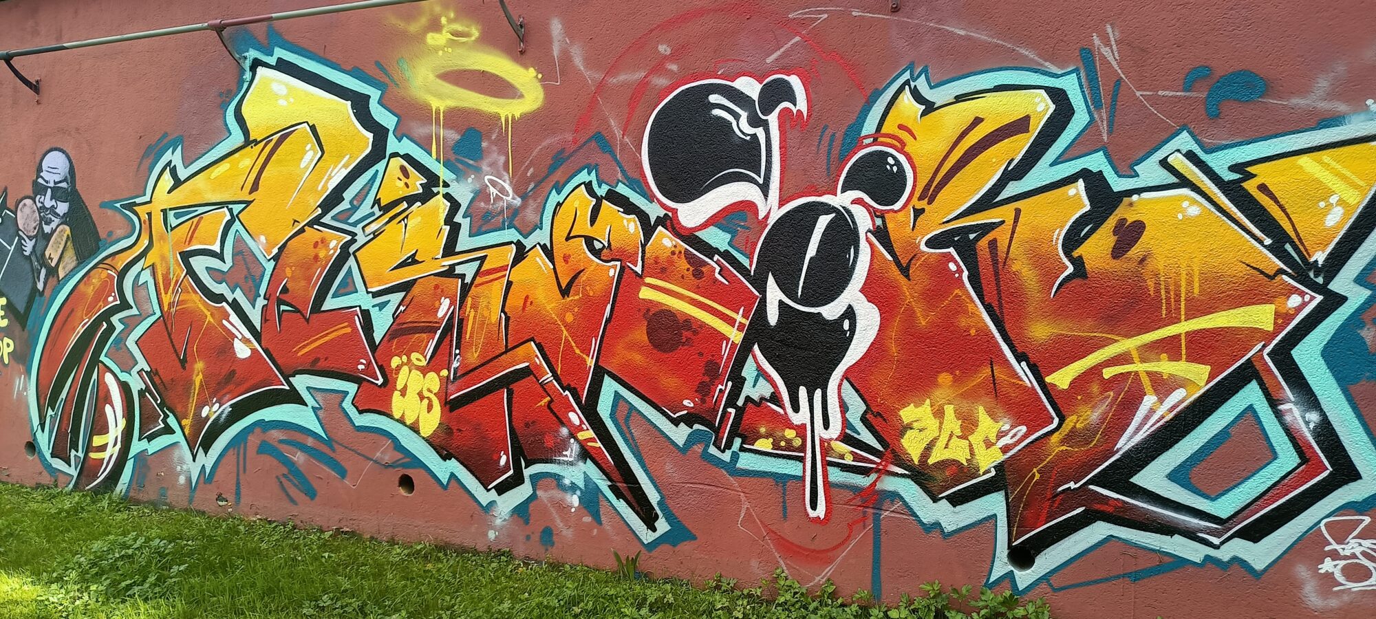 Lettrage orangé et personnages fondus — Street art à Nantes