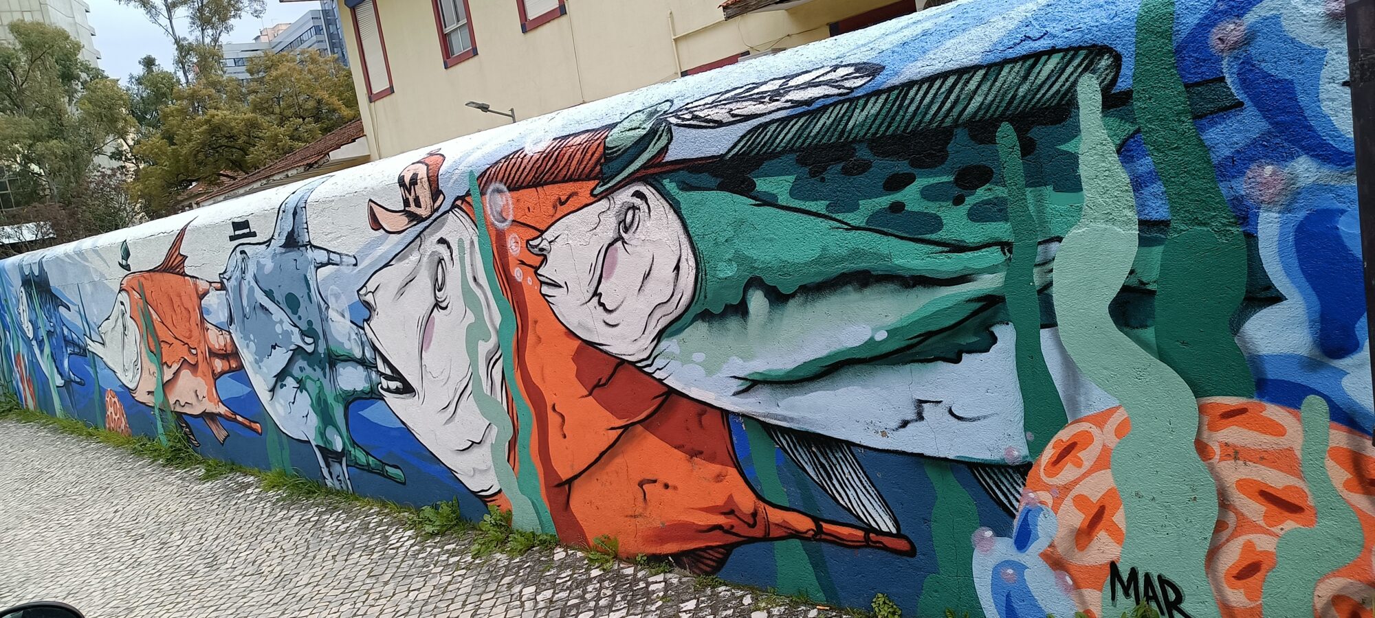 Hatted figures and fish — Street art by Mariana Rio in Lisboa