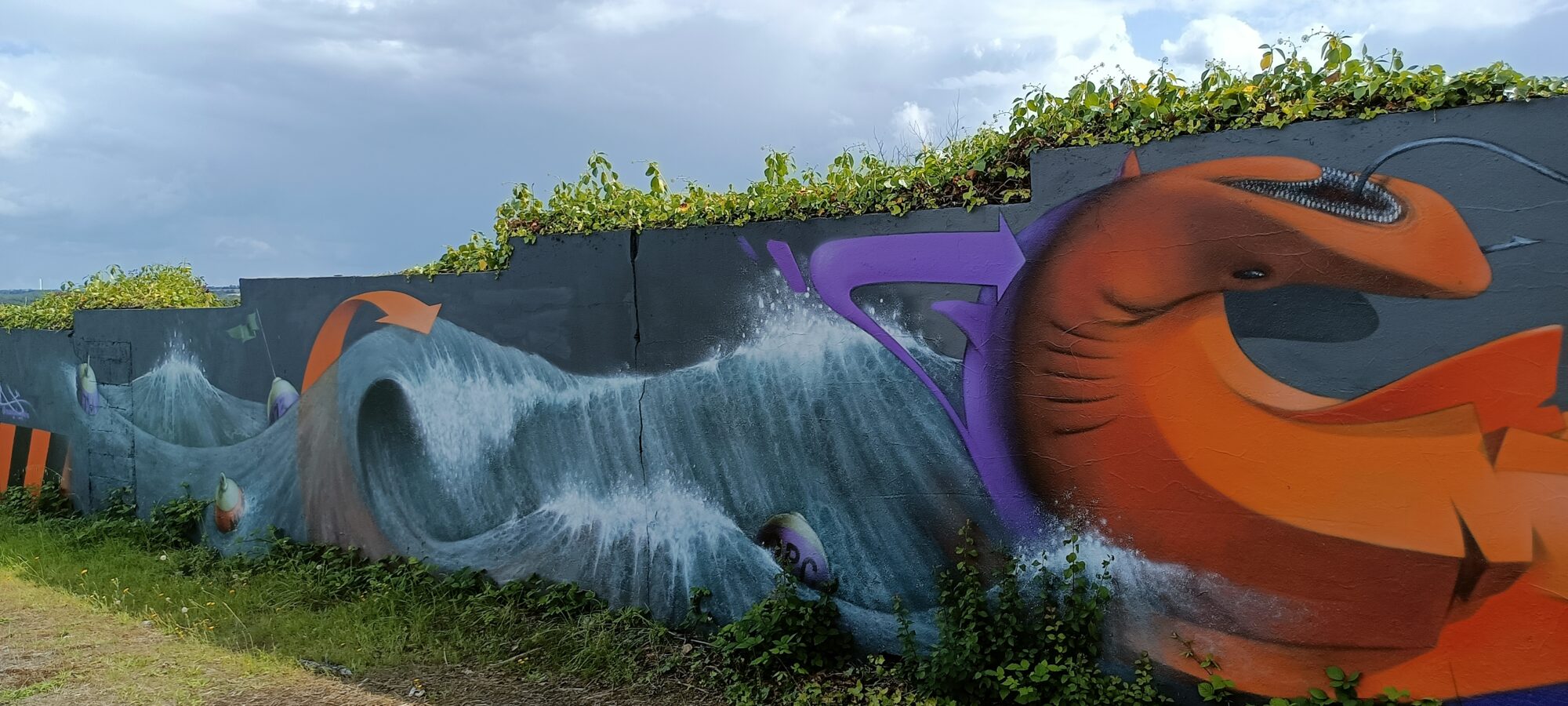 Wave and giant orange fish — Street art in Yffiniac