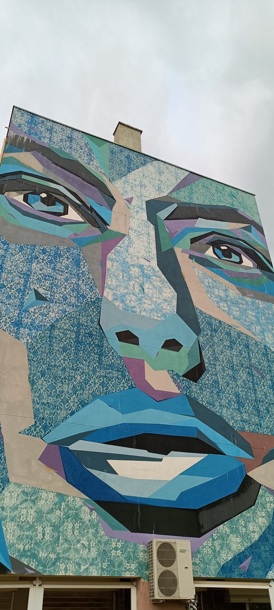 Monumental Face in Blue Facets — Street art by LS in Lisboa