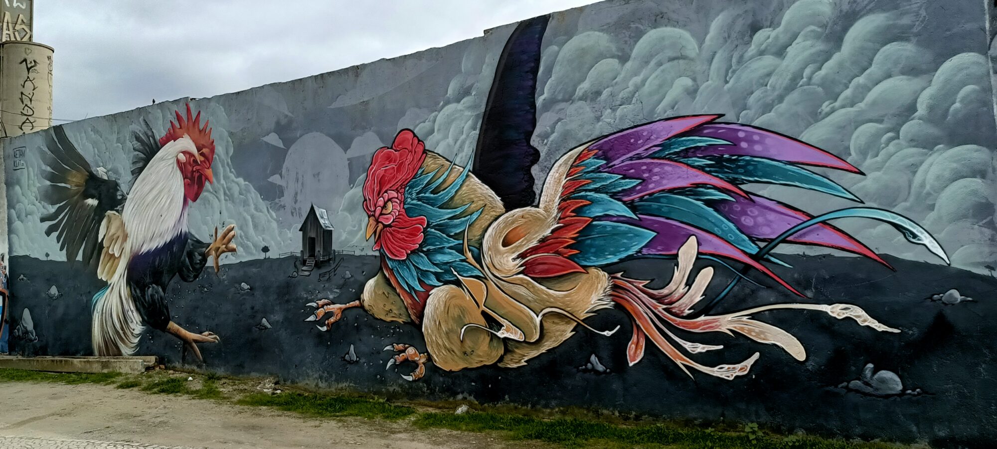 Cockfight against a Cloudy Sky — Street art by MS Ketam, Fredy Klit in Almada