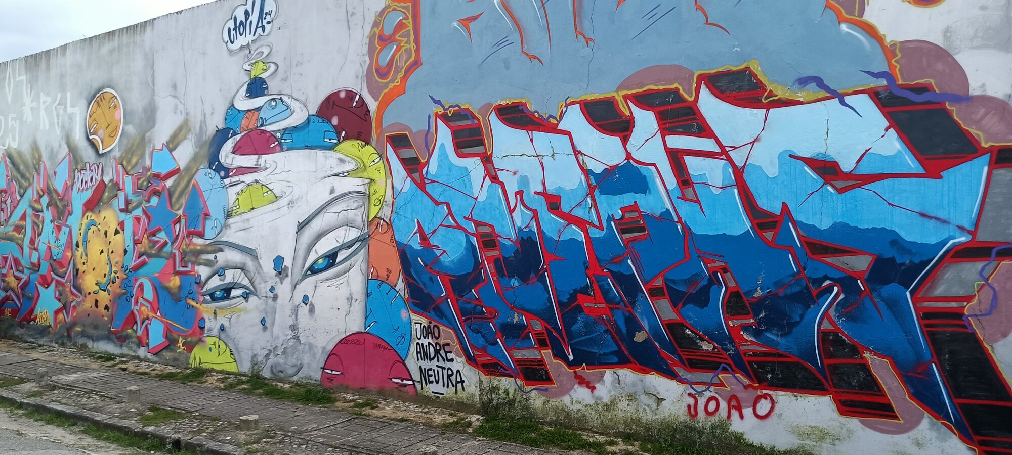 Blue and Red Lettering and Face with Hats — Street art by Utopia in Almada