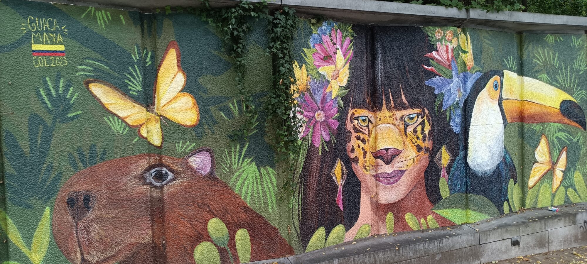 Capybara and woman with jaguar face paint — Street art by Mariana Betancur in Ixelles