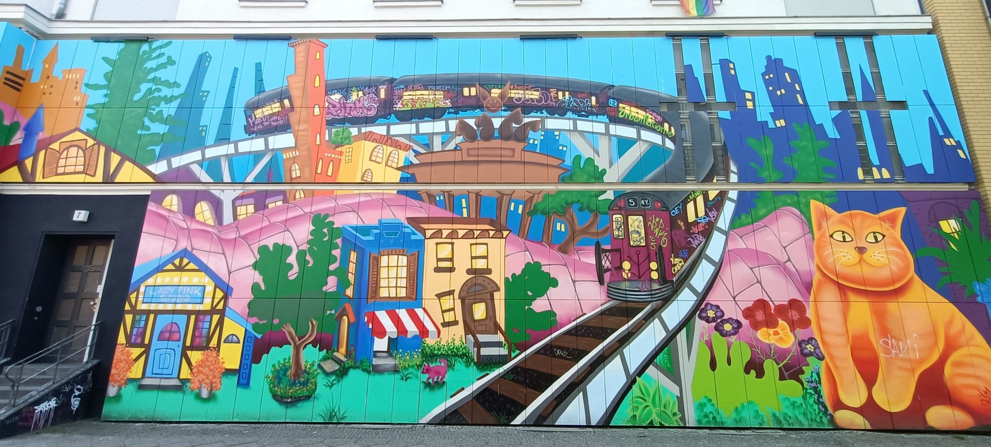 Fantasy City with Orange Cat — Street art in Berlin