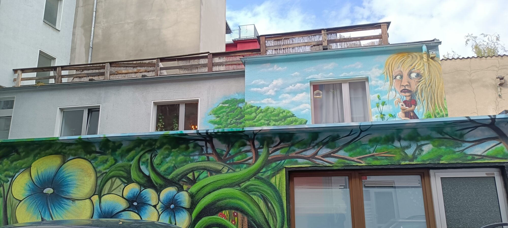 The girl with the rabbit and the flowering forest — Street art in Köln
