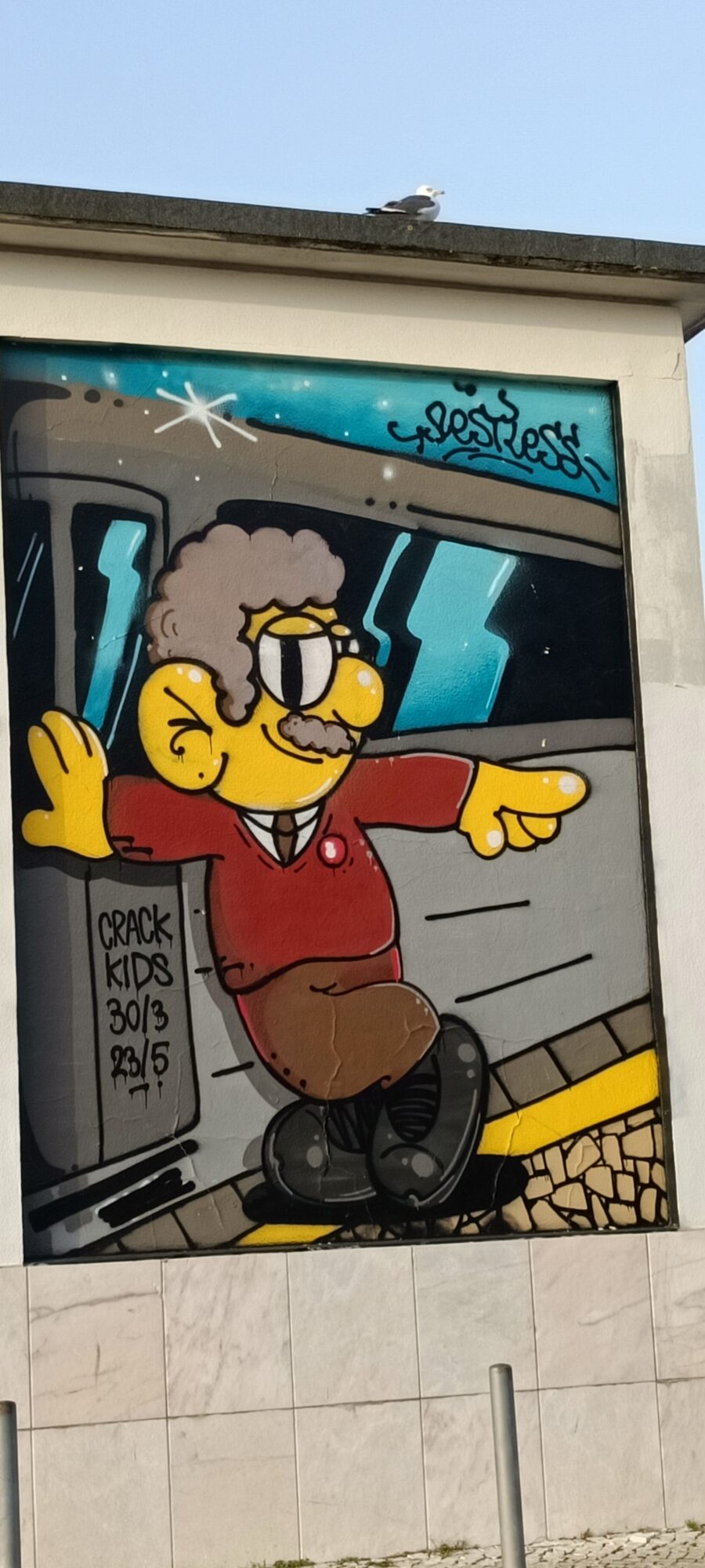 Yellow Character Stepping Off the Train — Street art in Lisboa