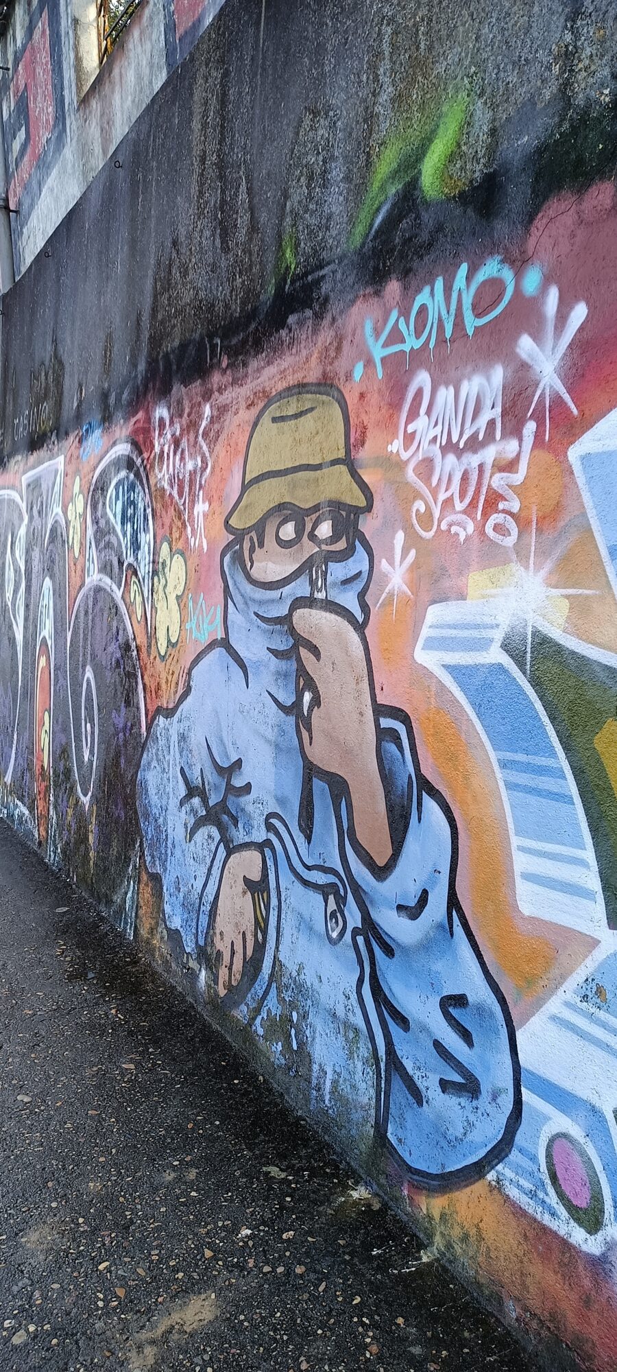 Figure in a Bucket Hat and Hood by Komo — Street art in Lisboa