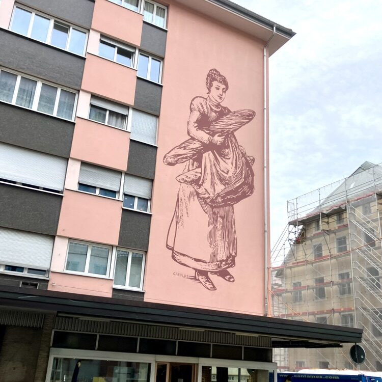 The Bread Carrier — Street art by Carolus in Le Locle