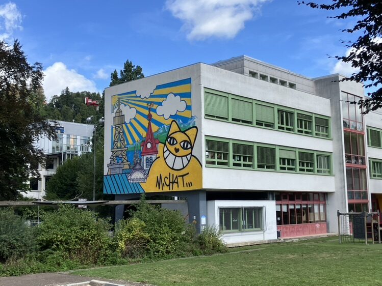 The Yellow Cat of Le Locle — Street art by M. Chat in Le Locle