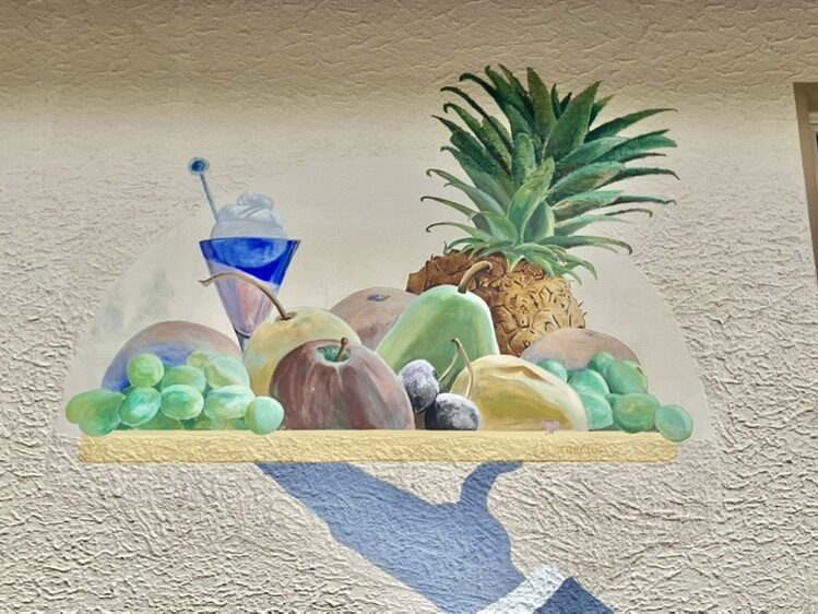 The Waiter with a Tray at Le Chevreuil — Street art by Carolus in La Chaux-de-Fonds