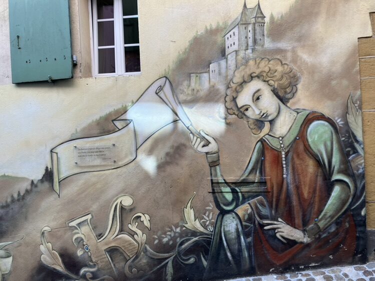 Figure with a Scroll before the Castle — Street art in Neuchâtel