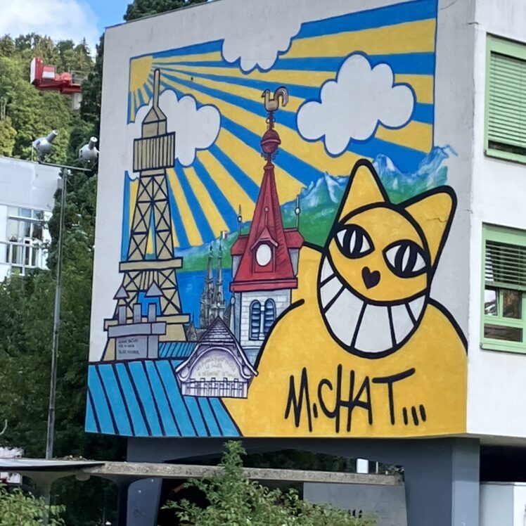 The Yellow Cat of Le Locle — Street art by M. Chat in Le Locle
