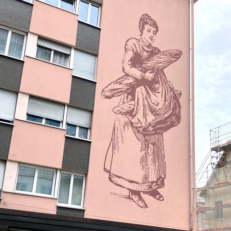 The Bread Carrier — Street art by Carolus in Le Locle