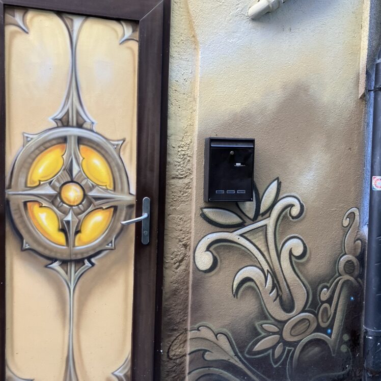 Golden Rosette on a Door — Street art in Neuchâtel