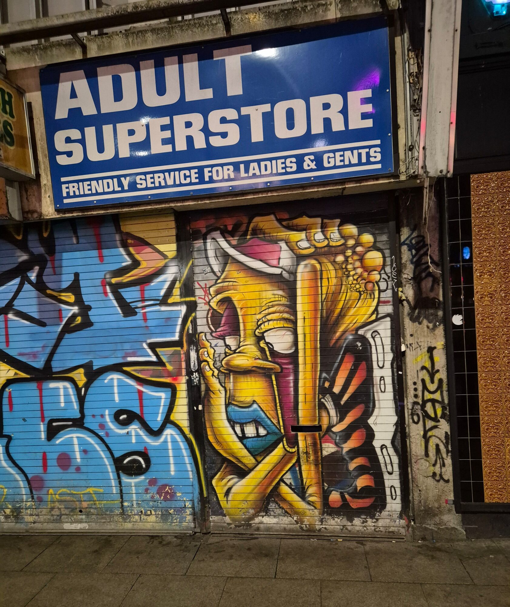 Yellow Character on a Shutter — Street art in Manchester