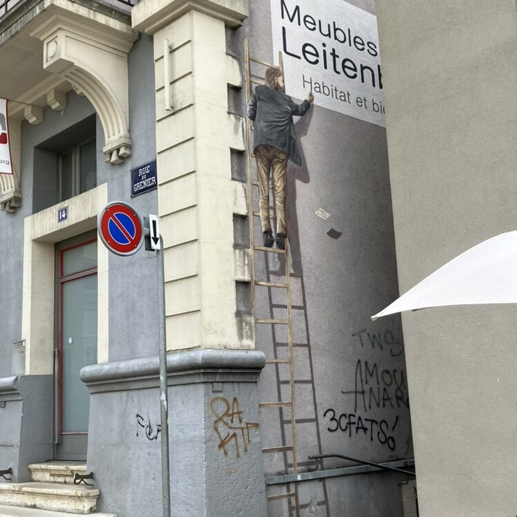 The Man on the Ladder — Street art by Carolus in La Chaux-de-Fonds