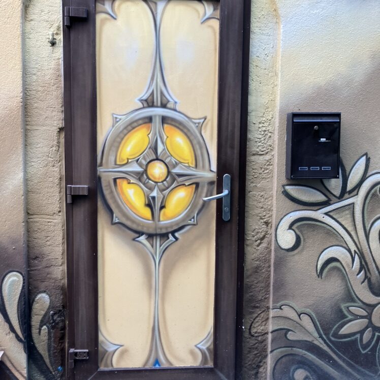 Golden Rosette on a Door — Street art in Neuchâtel