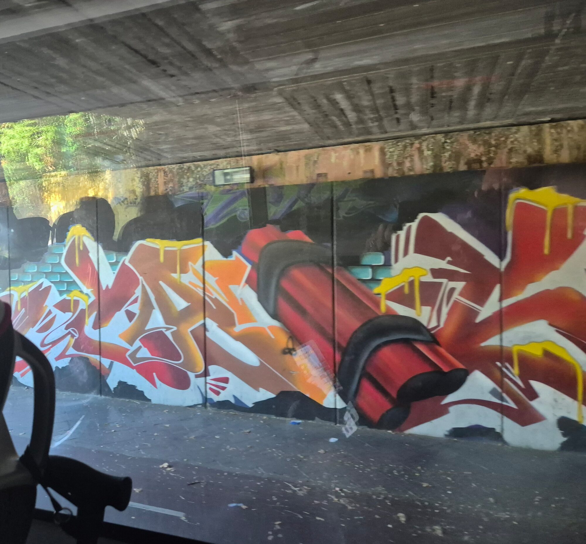 Red Lettering Under the Bridge — Street art in Jerez de la Frontera