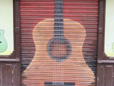 Acoustic Guitar on Shutter — Street art in Madrid