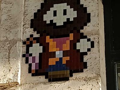 The White-Masked Figure in Mosaic — Street art by IN THE WOUP in Bourges