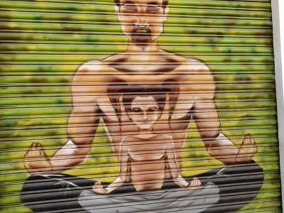Man Meditating with Child — Street art in Madrid