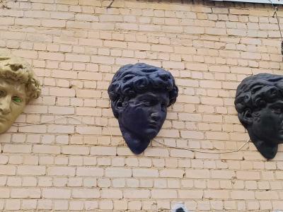 Three colored relief heads — Street art by Dalia Juodakytė & Laurynas Lubys in Vilnius