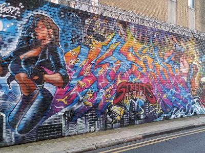 Superheroine on Grey Eagle Street — Street art in London