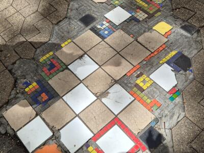 Ememem's multicoloured flacking in the paving — Street art by Ememem in Lyon